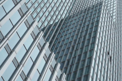 Low angle view of modern glass building in city