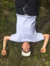 Young man lying on grass