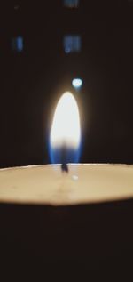 Close-up of illuminated lamp on table