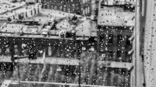 Full frame shot of wet glass window in rainy season