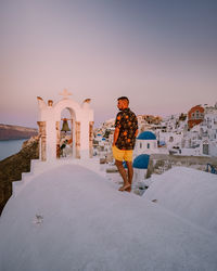 Man standing on snow covered landscape against sky