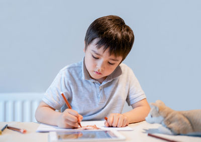 Full length of boy holding paper