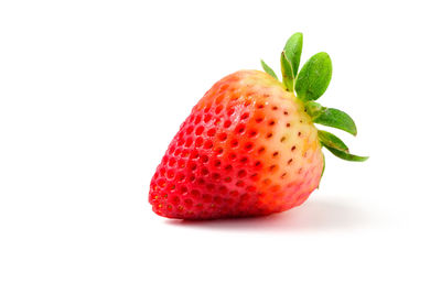 Close-up of strawberry over white background