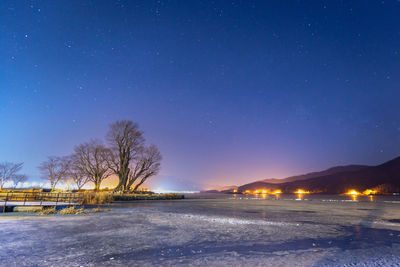 Scenic view of snow against sky at night