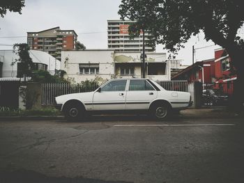 Side view of cars parked at roadside