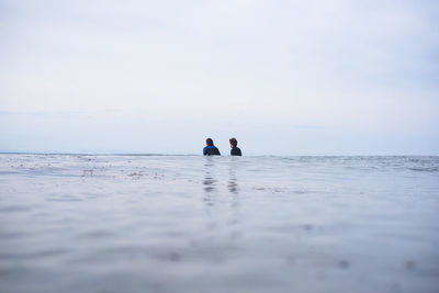 People on beach against sky