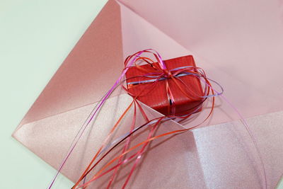 High angle view of gift and envelope on table