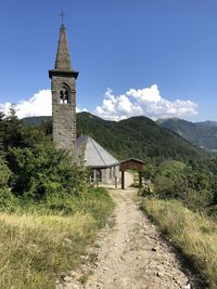 Walkway amidst church against sky, cisa italy 