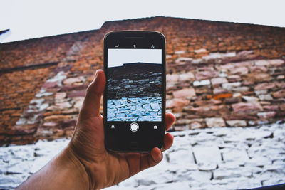Close-up of hand holding smart phone
