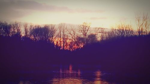 Scenic view of lake against sky at sunset