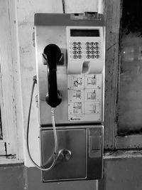 Close-up of telephone booth on wall