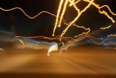 Close-up of light trails against sky at night
