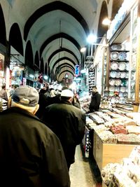 Full length rear view of man standing on escalator