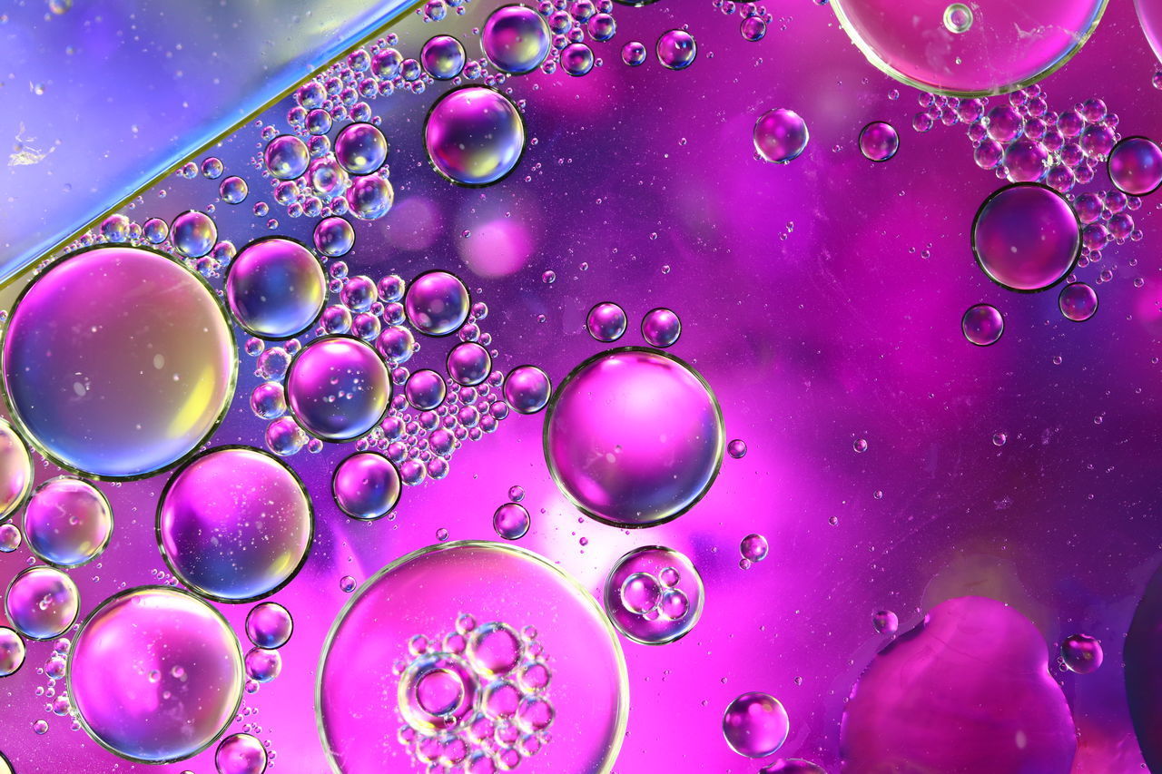 CLOSE-UP OF WATER DROPS ON PINK BUBBLES