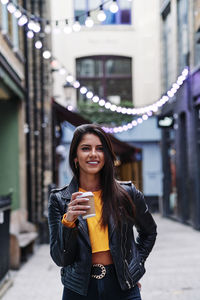 Portrait of smiling young woman standing outdoors