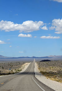 Scenic view of road against blue sky