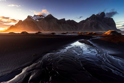 Scenic view of sea and mountains against sky