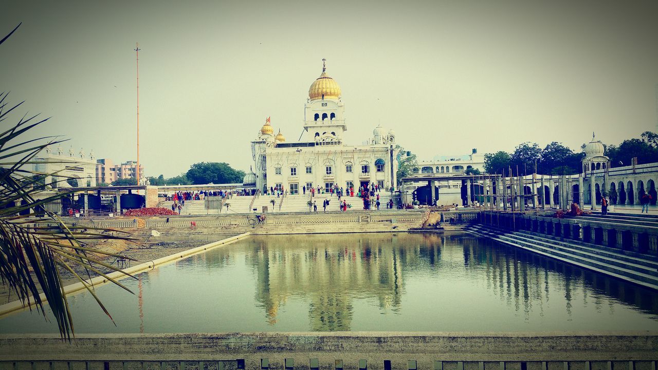 architecture, built structure, building exterior, religion, place of worship, water, clear sky, spirituality, dome, reflection, church, famous place, travel destinations, travel, waterfront, tourism, river, incidental people