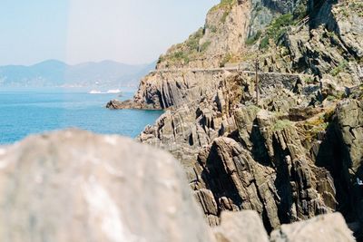 Scenic view of sea and mountains against sky