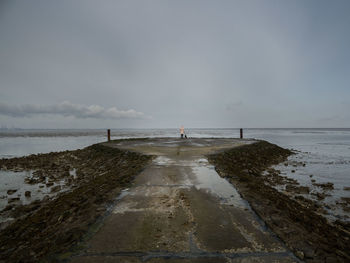 Pier over sea against sky