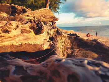 Scenic view of rocks on beach against sky