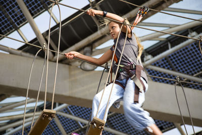 Full length of woman holding rope