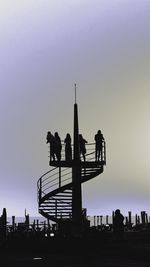 Silhouette people at observation point against sky