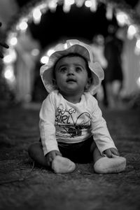 Portrait of cute girl sitting outdoors