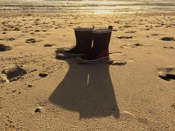 Close-up of shadow on sand at beach