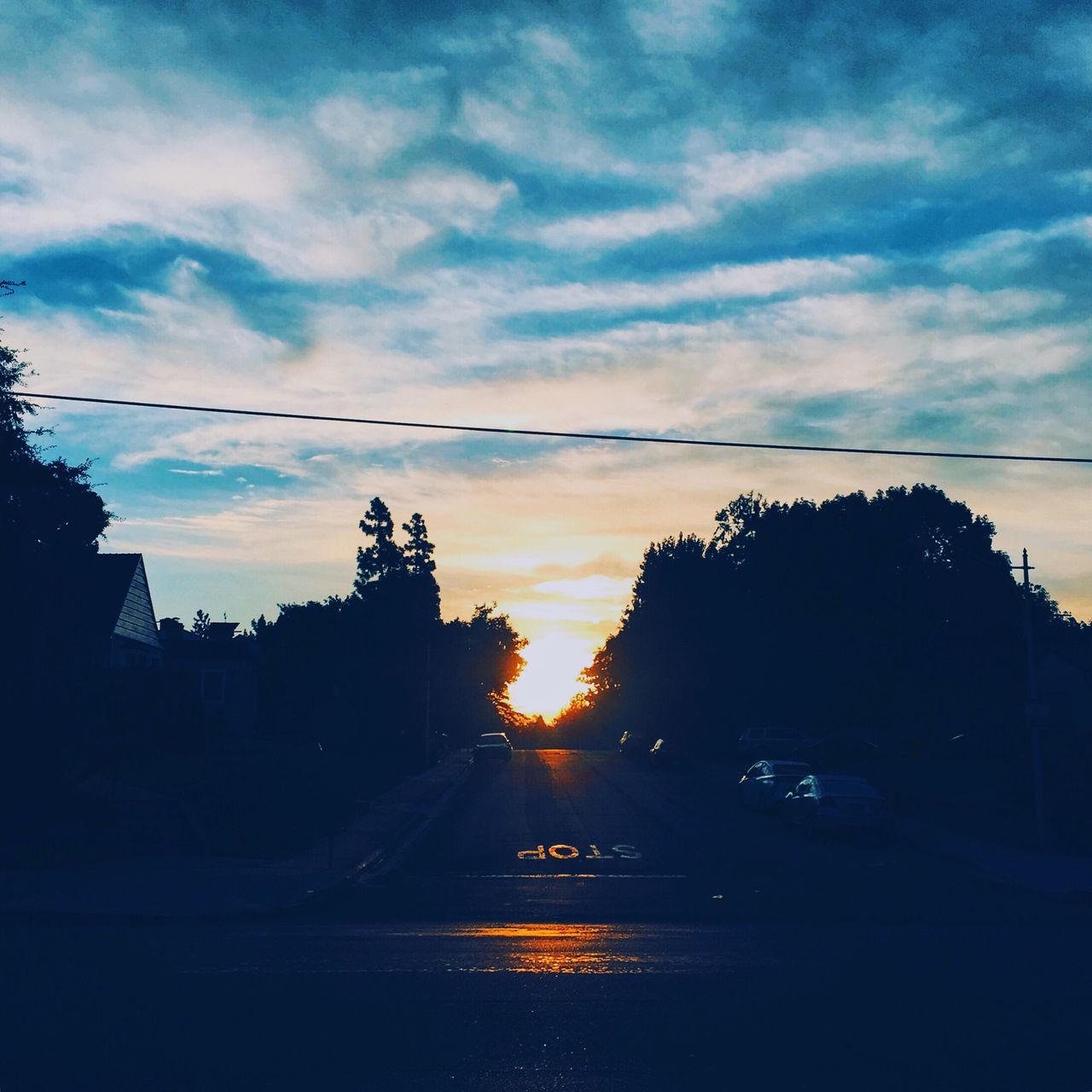 sunset, transportation, silhouette, road, tree, sky, the way forward, street, cloud - sky, diminishing perspective, mode of transport, cloud, tranquil scene, cloudy, sun, vanishing point, tranquility, blue, scenics, outdoors, country road, beauty in nature, nature, empty road, outline, no people