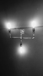 Illuminated lamp hanging in room