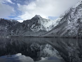 Scenic view of lake and snowcapped mountains against sky