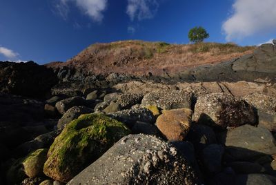 Rocks on land against sky