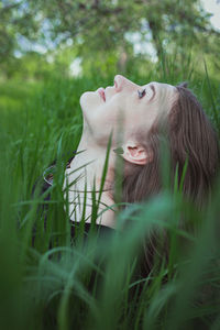 Close up woman in tall grass looking up at sky portrait picture