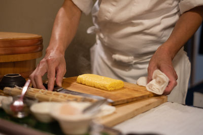 Midsection of man preparing food