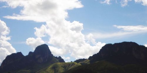 Scenic view of mountains against blue sky