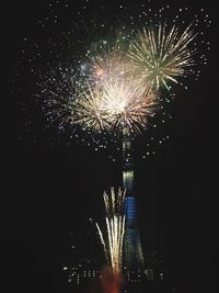 Low angle view of firework display at night