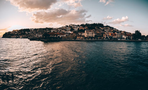 Town by sea against sky in city