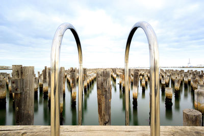 Panoramic view of wooden posts on princes pier against sky