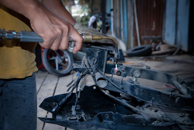 Low section of man repairing car