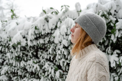 Side view of woman looking at snow