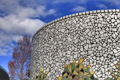 Low angle view of building against cloudy sky