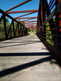 Footbridge over suspension bridge against sky