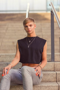 Portrait of teenage boy sitting on staircase