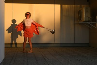 Full length portrait of young woman standing in gym