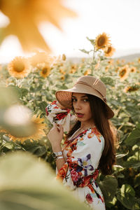 Woman standing by flowering plants