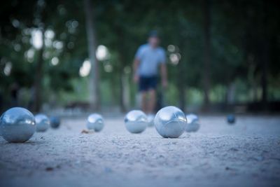 Man playing with balls on field