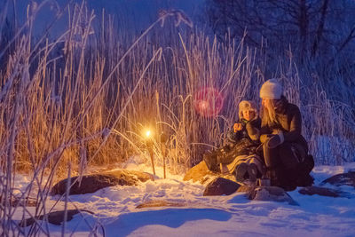 Mother and child in snow at night