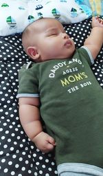 High angle view of baby lying on bed