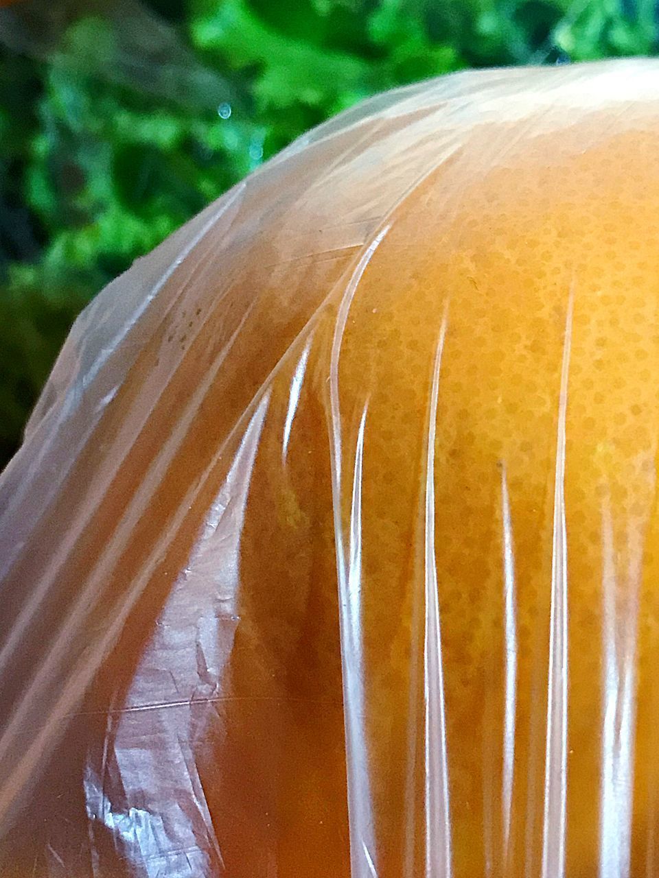 CLOSE-UP OF ORANGE SLICE ON GROUND